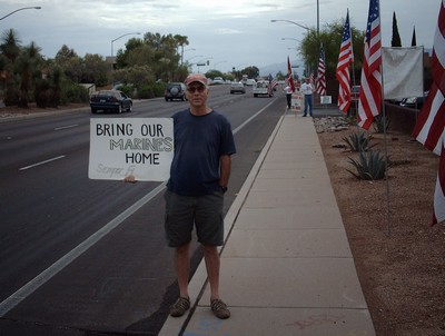 Semper Fraud with Bring Our Marines Home sign